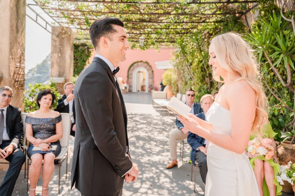 Emotional Wedding Vow Exchange at Villa Magia A bride reads her personal vows to the groom from a book during their emotional villa magia wedding positano ceremony