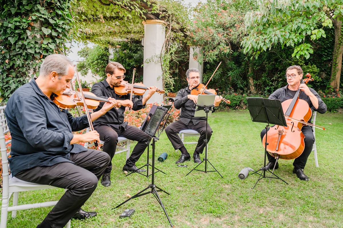 String Quartet Performing at a Garden Wedding A string quartet performs in a lush garden, providing elegant live music for a Palazzo Confalone wedding Ravello