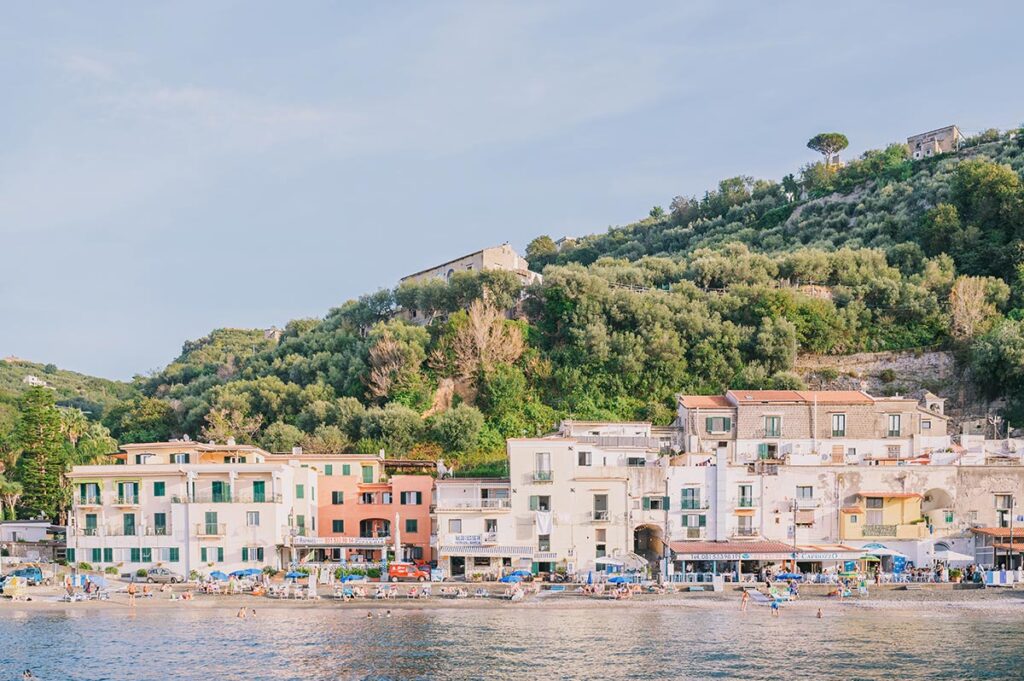 Picturesque waterfront buildings with lush hills, a romantic setting for a wedding in Sorrento