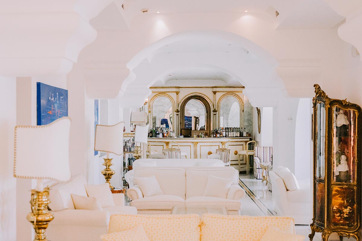 Elegant White and Gold Hotel Lounge Bar The stunning all-white and gold hotel lounge bar, an elegant feature of a luxury Palazzo Avino wedding Ravello experience