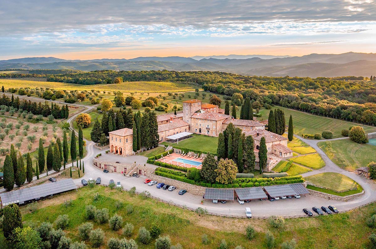 A breathtaking aerial view of a Chianti wedding venue, featuring a historic Tuscan estate surrounded by vineyards and rolling hills