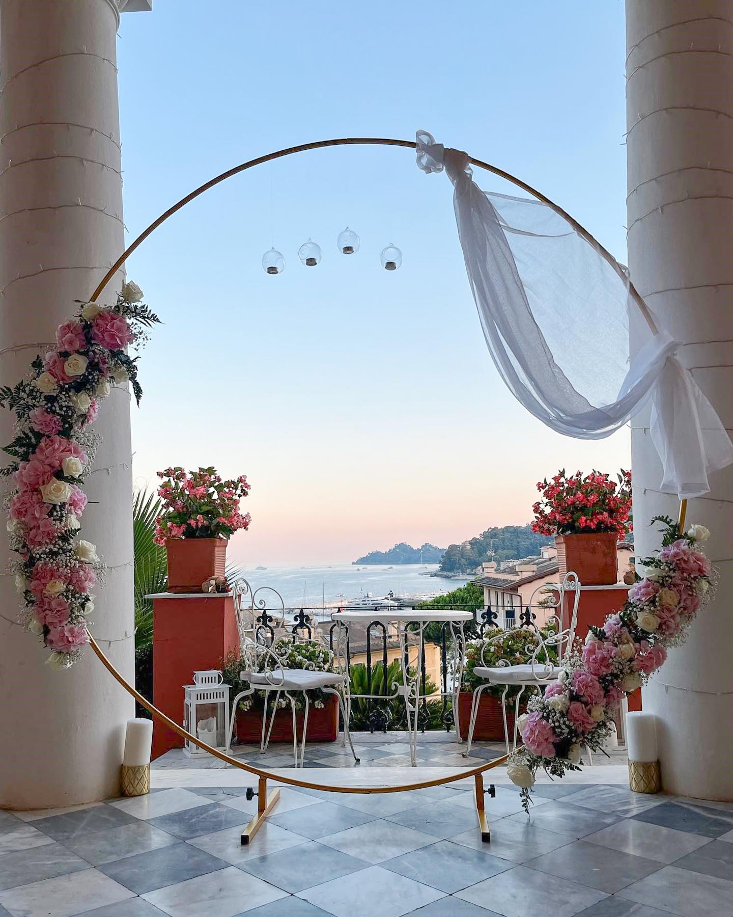 A romantic wedding setup on a terrace overlooking the Italian coast, showcasing the hidden costs of a DIY wedding in Italy